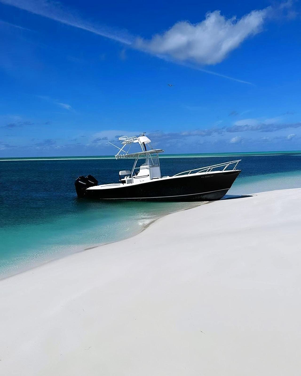 A center-console boat on calm clear water off Spanish Wells, North Eleuthera.