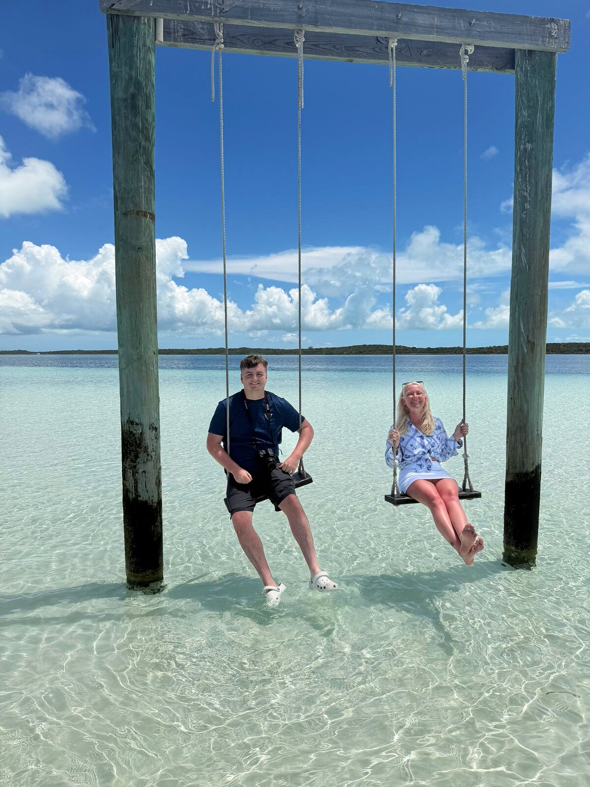 A couple enjoying calm turquoise water near Harbour Island, Bahamas.